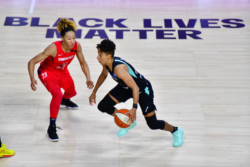 PALMETTO, FLORIDA - AUGUST 07: Layshia Clarendon #7 of the New York Liberty is guarded by Aerial Powers #23 of the Washington Mystics in front of a Black Lives Matter graphic on court during the second half of a game at Feld Entertainment Center on August 07, 2020 in Palmetto, Florida. NOTE TO USER: User expressly acknowledges and agrees that, by downloading and or using this photograph, User is consenting to the terms and conditions of the Getty Images License Agreement. (Photo by Julio Aguilar/Getty Images)