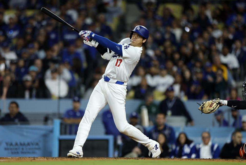 Los Angeles, California - April 3: Los Angeles Dodgers No. 17 Shohei Ohtani hits a solo home run in the bottom of the seventh inning against the San Francisco Giants at Dodger Stadium (April 3, 2024, Los Angeles, California) . This home run was Ohtani's first with the Dodgers.  (Photo by Kevork Djansezian/Getty Images)