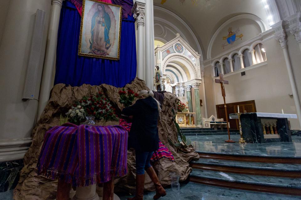 El Pasoans bring roses to the Virgen de Guadalupe on her patron saint day Tuesday morning, Dec. 12, 2023, at St. Patrick Cathedral.