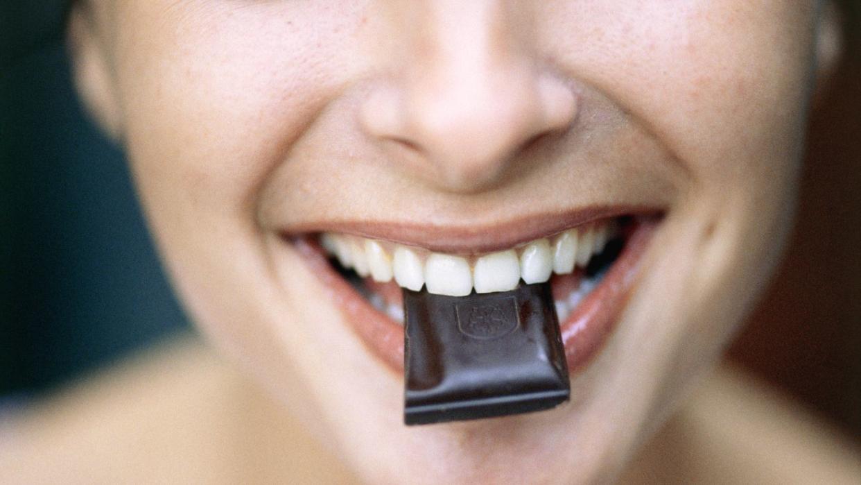 young woman eating chocolate