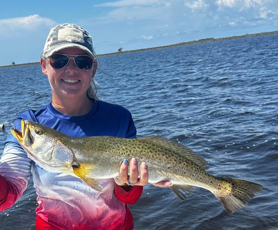 Malerie Martin holds up a beautiful 25” trout she caught while fishing with her husband Asa. Captain Asa owns Angry Fish Inshore Charters and says fishing is excellent