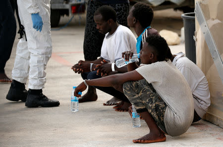 A migrant drinks water after disembarking from an Armed Forces of Malta patrol boat at its base in Marsamxett Harbour, Valletta, Malta May 25, 2019. REUTERS/Darrin Zammit Lupi