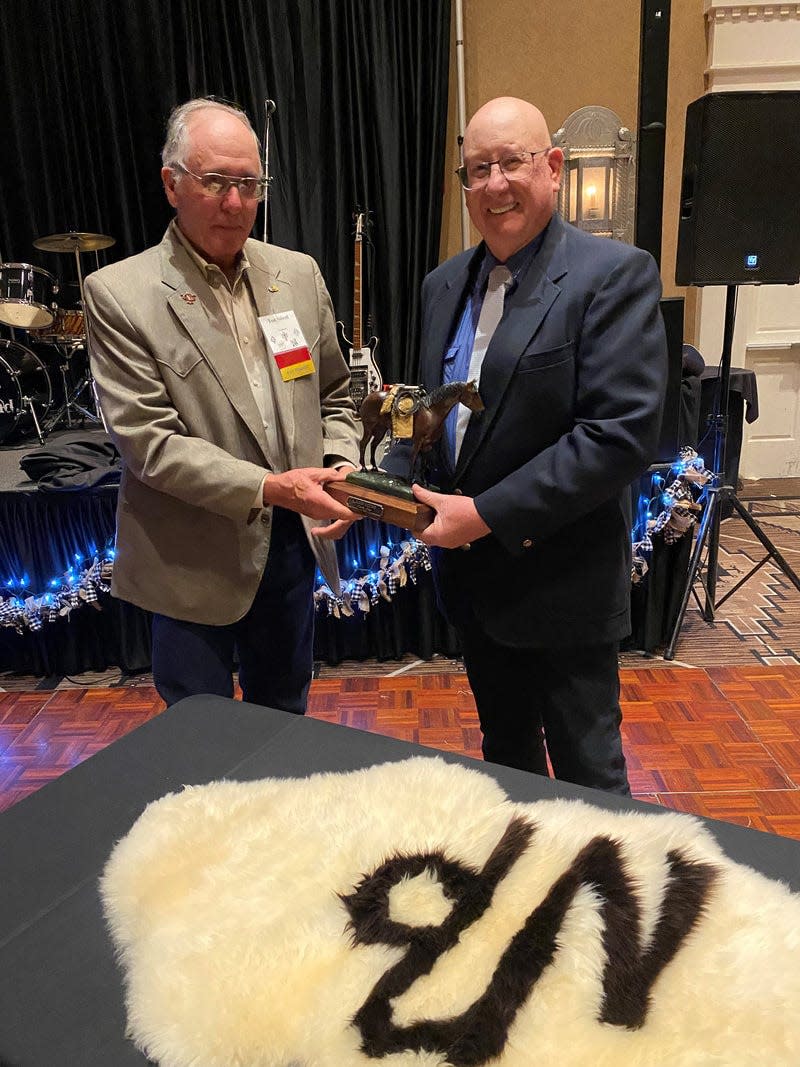 Tom Sidwell (left) awards former Artesia resident Darrell Brown with the 2022 Cattlemen of the Year award in Albuquerque. Brown received the award from the New Mexico Cattle Growers' Association.