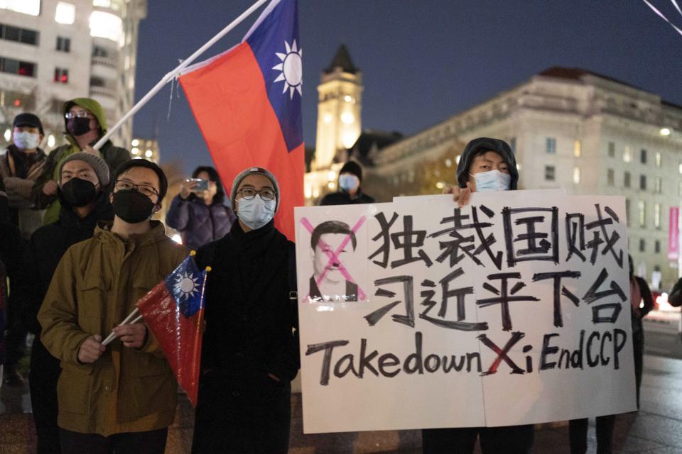 A person holds a sign as demonstrators gather at Freedom Plaza in Washington, Sunday, Dec. 4, 2022, to protest in solidarity with the ongoing protests against the Chinese government's continued zero-COVID policies. (AP Photo/Jose Luis Magana)