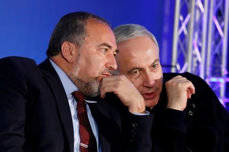 FILE PHOTO: Israel's Prime Minister Netanyahu converses with former Foreign Minister Lieberman during a campaign rally in Ashdod