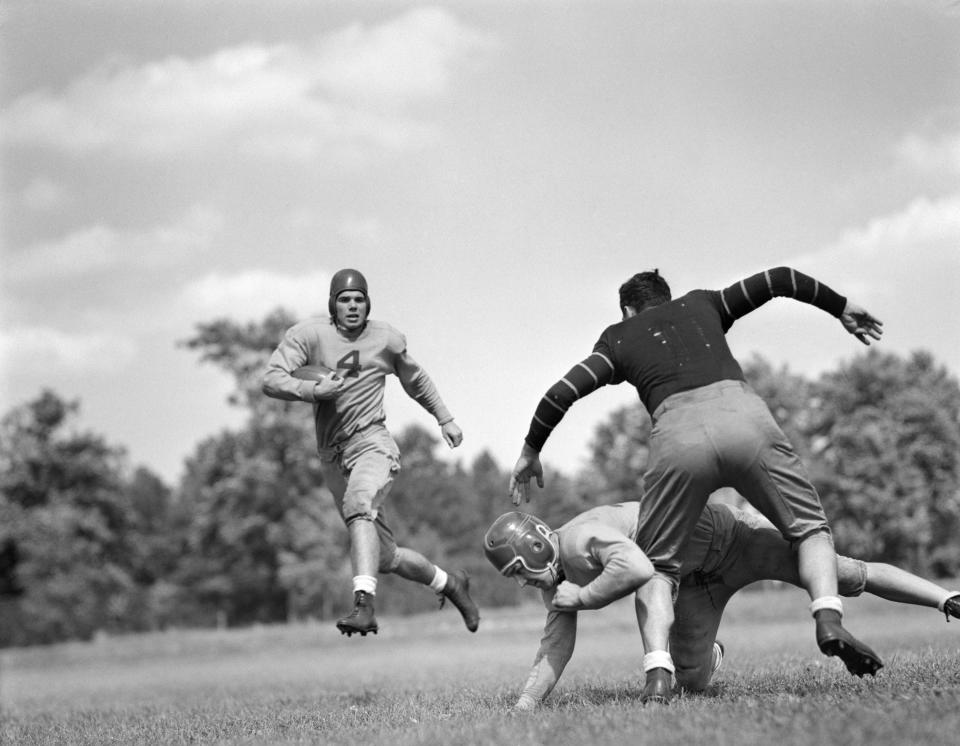 Football players in leather helmets