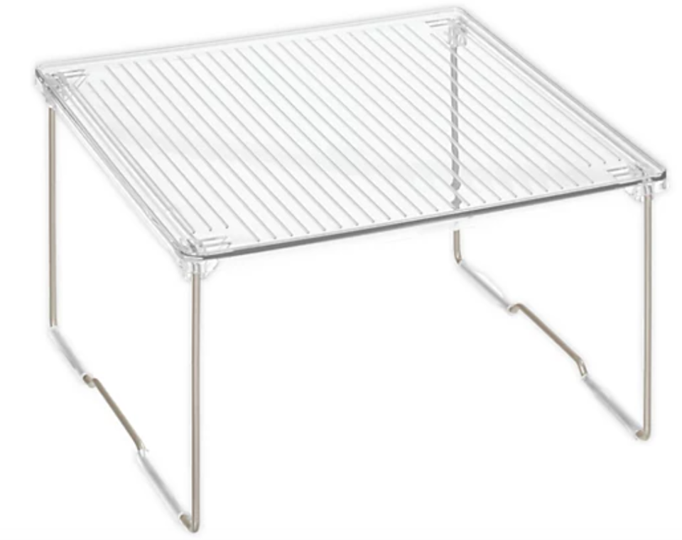 metal legs and clear plastic top shelf on white ground 