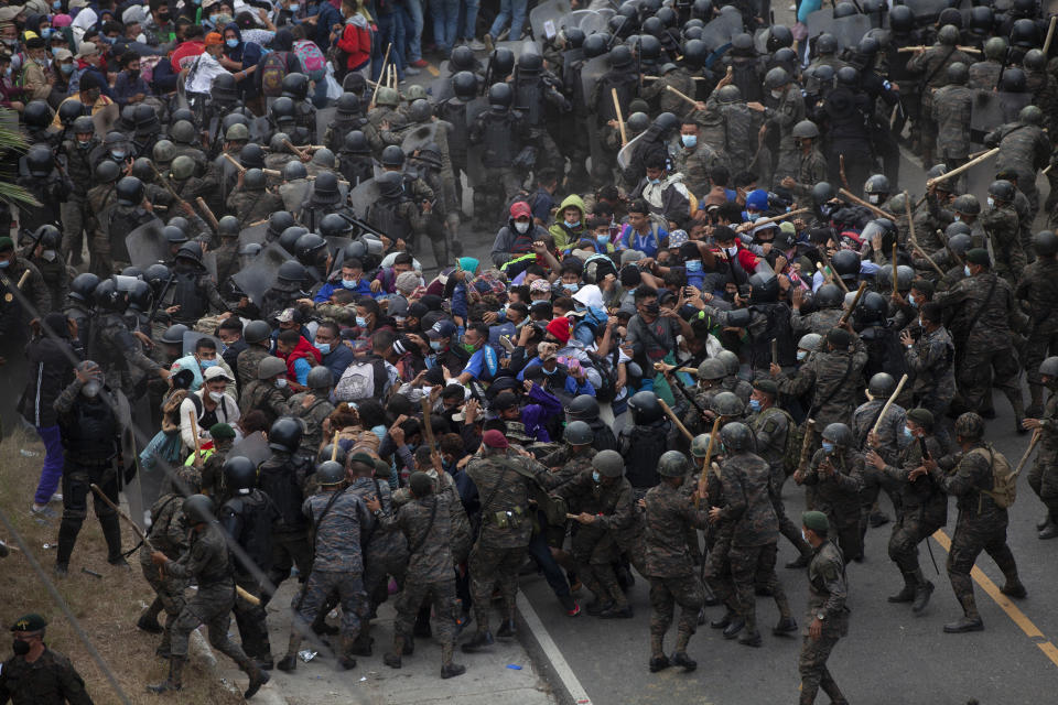 Honduran migrants clash with Guatemalan soldiers in Vado Hondo, Guatemala, Sunday, Jan. 17, 2021. Guatemalan authorities estimated that as many as 9,000 Honduran migrants crossed into Guatemala as part of an effort to form a new caravan to reach the U.S. border. (AP Photo/Sandra Sebastian)