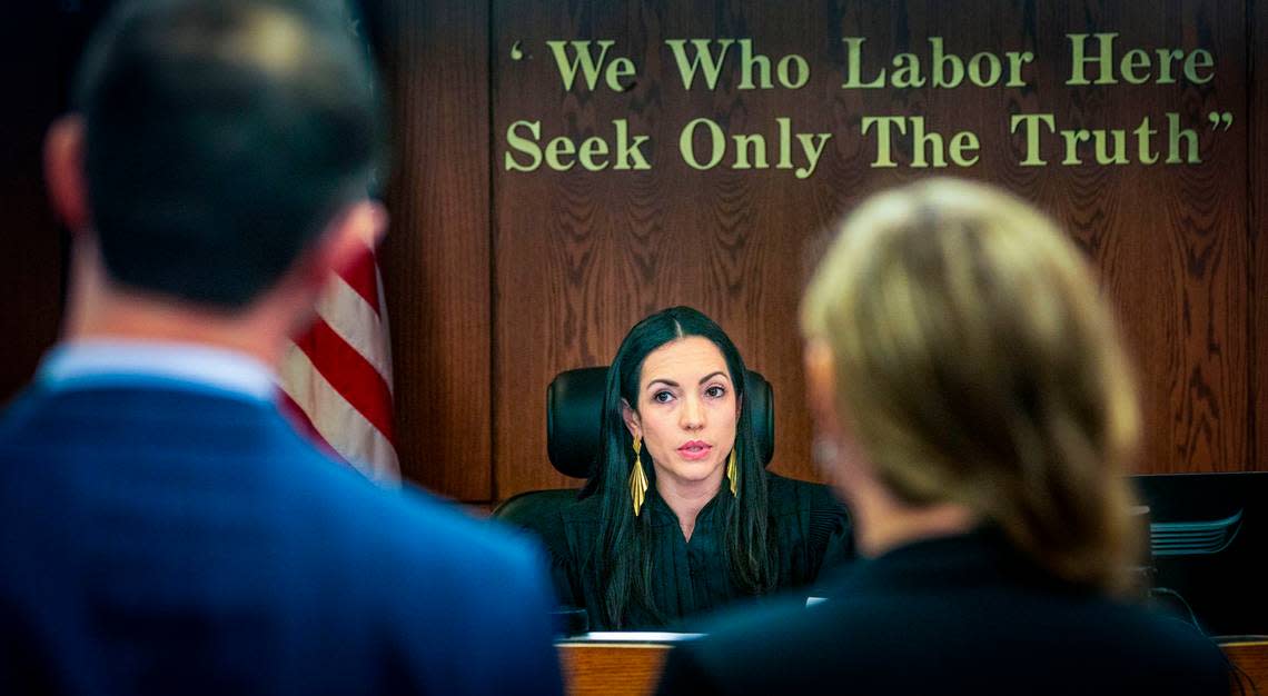 Judge Cristina Rivera Correa talks to Public defenders Robert Keilson (left) and Chandra Sim during a hearing of a Mom named Gamaly Argentina Hollis, who is being held in jail after being accused of stalking a Miami-Dade cop who killed her mentally ill son. The hearing took place at the Gerstein Justice Bldg in Miami on Thursday, March 7, 2024.