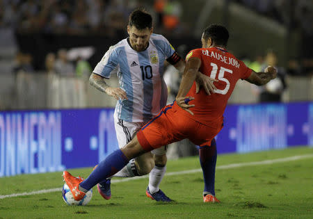 Football Soccer - Argentina v Chile - World Cup 2018 Qualifiers - Antonio Liberti Stadium, Buenos Aires, Argentina - 23/3/17 - Argentina's Lionel Messi (L) and Chile's Jean Beausejour compete for the ball. REUTERS/Alberto Raggio