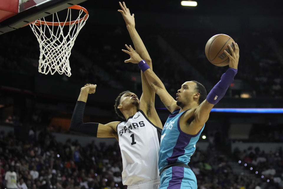 San Antonio Spurs' Victor Wembanyama, left, fouls Charlotte Hornets' Amari Bailey during the second half of an NBA summer league basketball game Friday, July 7, 2023, in Las Vegas. (AP Photo/John Locher)