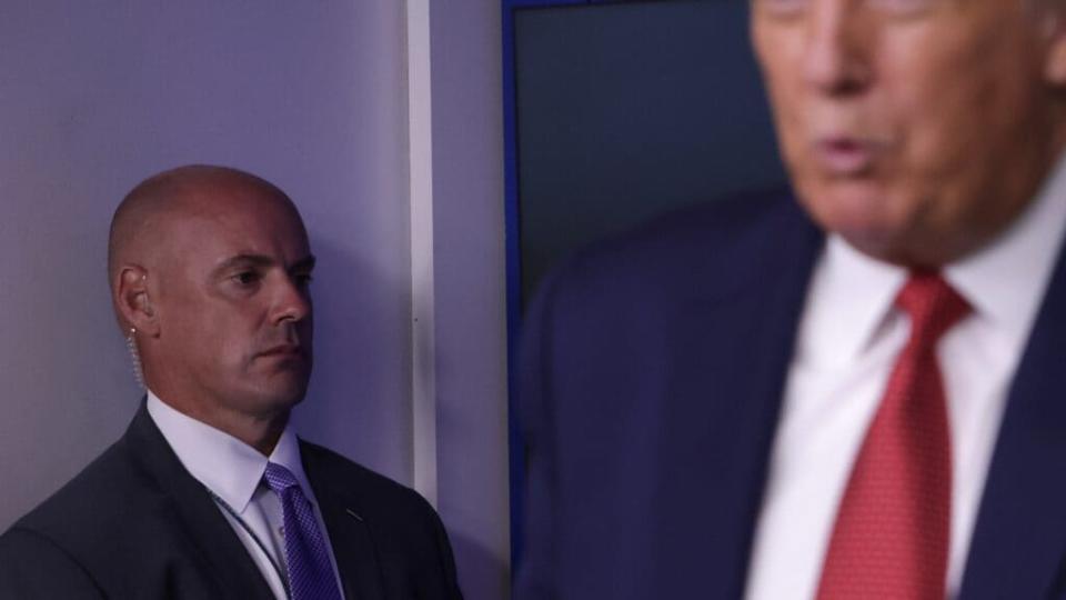 A Secret Service agent stands near President Donald Trump while he speaks during a news conference in the James Brady Press Briefing Room of the White House. (Photo by Alex Wong/Getty Images)