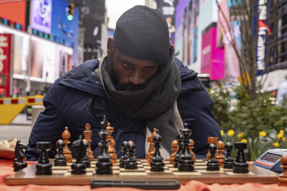 Tunde Onakoya, a Nigerian chess champion and child education advocate, plays a chess game in Times Square, Friday, April 19, 2024, in New York. (AP Photo/Yuki Iwamura)