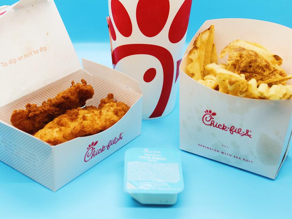 chick fil a chicken tenders fries sauce cup on blue background