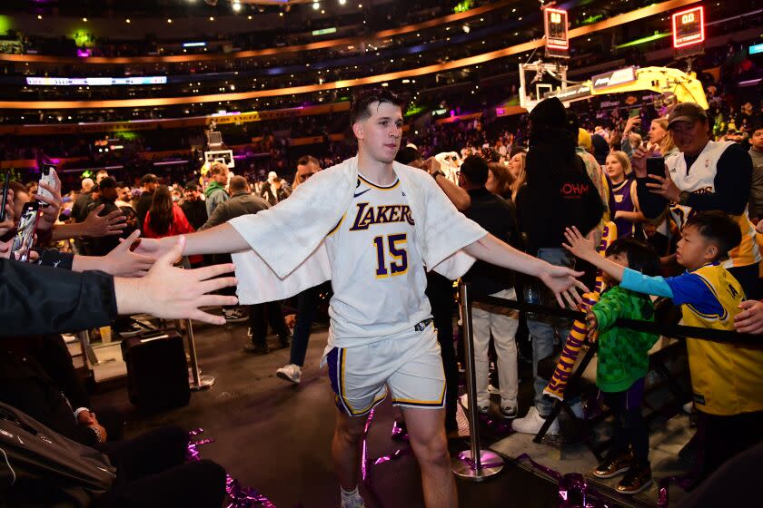 LOS ANGELES, CA - MARCH 19: Austin Reaves #15 of the Los Angeles Lakers walks off the court.