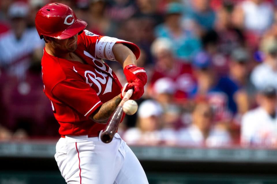 Cincinnati Reds center fielder Nick Senzel (15) hits an RBI base hit in the fifth inning of the MLB game between the Cincinnati Reds and the Atlanta Braves at Great American Ball Park in Cincinnati on Saturday, July 2, 2022.