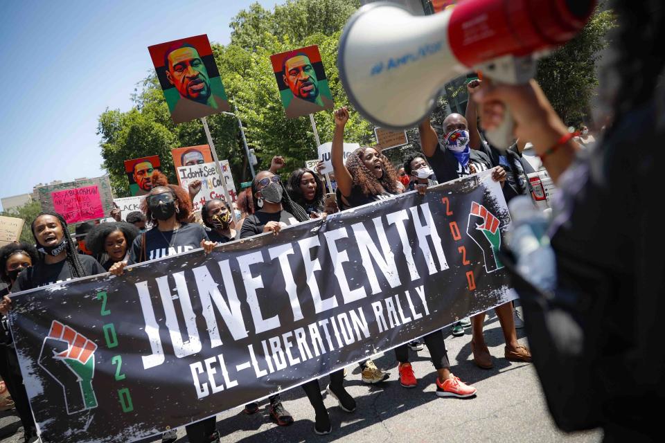 FILE - In this Friday, June 19, 2020, file photo, demonstrators protest during a Juneteenth rally at the Brooklyn Museum, in the Brooklyn, N.Y. President Joe Biden signed into law Thursday, June 17, 2021, a bill designating Juneteenth—which commemorates June 19, 1865 when enslaved people in Texas learned they had been freed—as the 11th federal holiday. (AP Photo/John Minchillo, File)