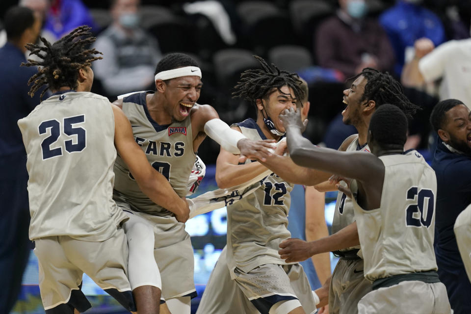 Shawnee State's Latavious Mitchell (25), Donoven Carlisle (30), Tre Beard (12), Amier Gilmore (0) and Issac Abergut (20) celebrate following the final of the NAIA college basketball tournament in Kansas City, Mo., Tuesday, March 23, 2021. Shawnee State defeated Lewis-Clark State. (AP Photo/Orlin Wagner)