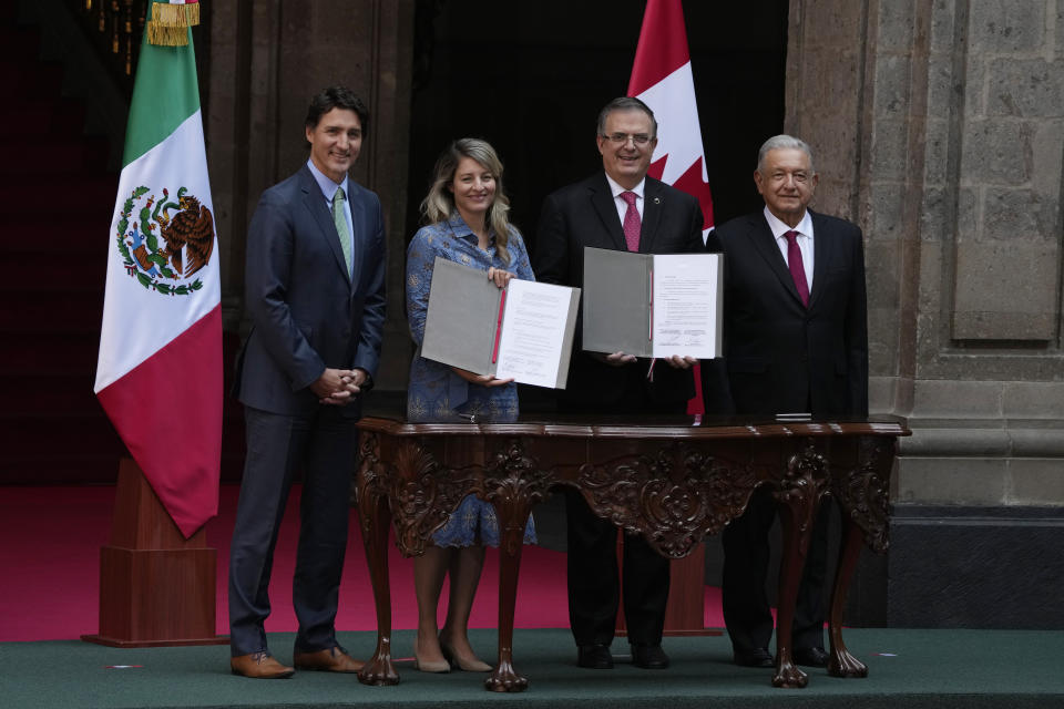Canadian Prime Minister Justin Trudeau, left, his Foreign Minister Melanie Joly, second from left, Mexican President Andres Manuel Lopez Obrador, right, and his Foreign Minister Marcelo Ebrard pose for photos during an agreement signing ceremony at the National Palace in Mexico City, Wednesday, Jan. 11, 2023. (AP Photo/Fernando Llano)