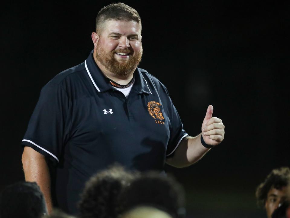 Lely Trojans head coach Ben Hammer smiles after defeating the Estero Wildcats 28-27 in a spring football game at Lely High School in Naples on Friday, May 19, 2023.