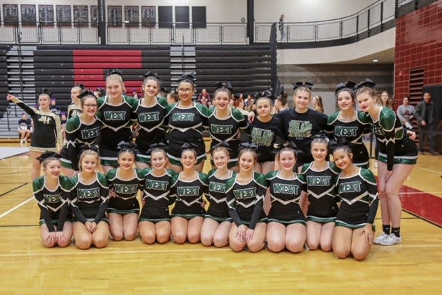 The Zeeland West competitive cheer team finished second at districts to qualify for regionals for the first time.