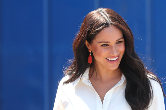 meghan markle wearing white shirt with red earrings against blue background, Can&#39;t afford Meghan Markle&#39;s $4,100 Chlo&#xe9; bag? Shop six dupes for less (Photo by Chris Jackson/Getty Images)