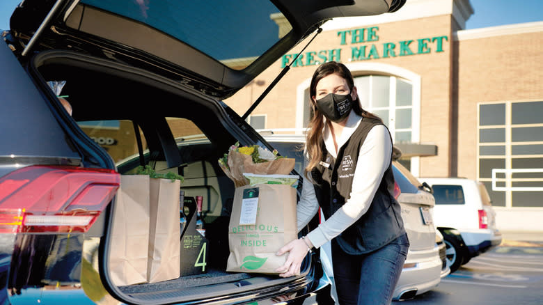 putting groceries in car