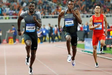 Justin Gatlin (L) of the U.S. competes. Athletics - IAAF Athletics Diamond League meeting - Men's 100m - Shanghai Stadium, Shanghai, China - 14/5/16. REUTERS/Aly Song