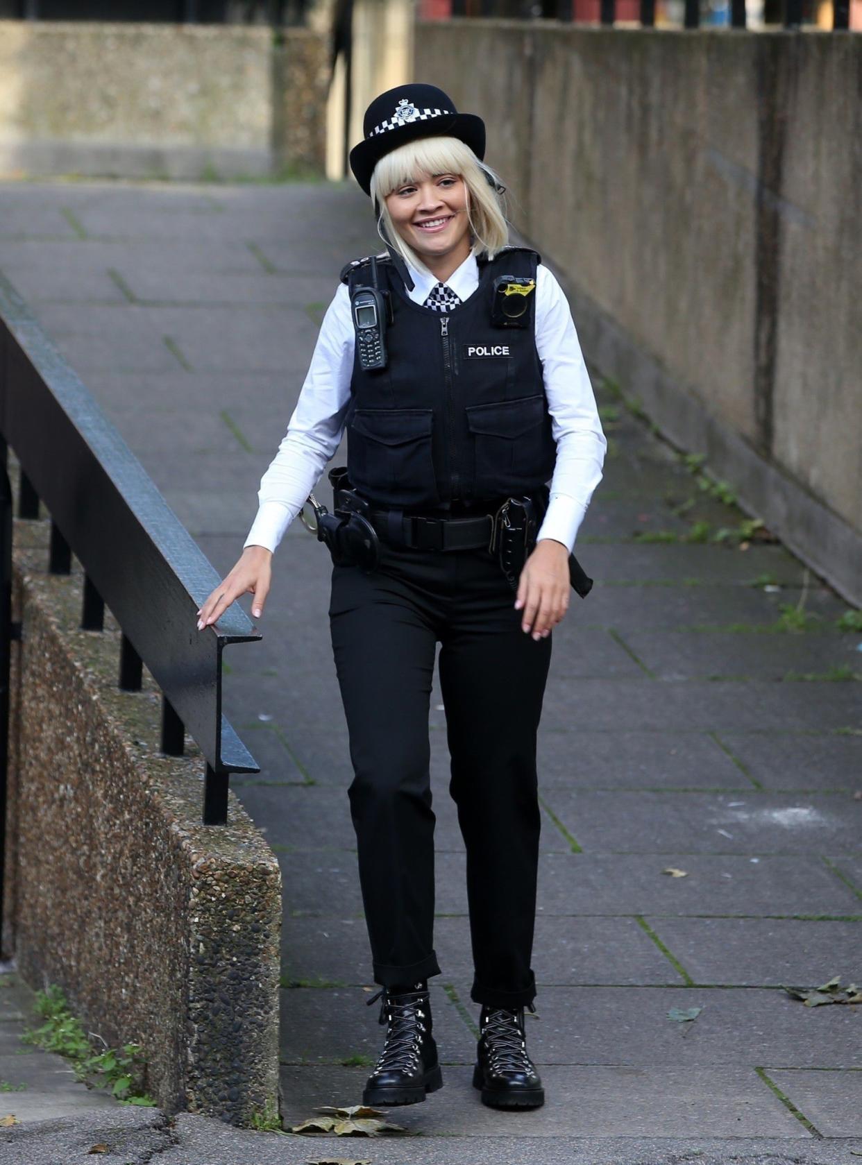 Rita Ora wears a police uniform on the set of "Twist," a modernized Oliver Twist remake of the classic Charles Dickens novel, on Oct. 22, 2019, in London.