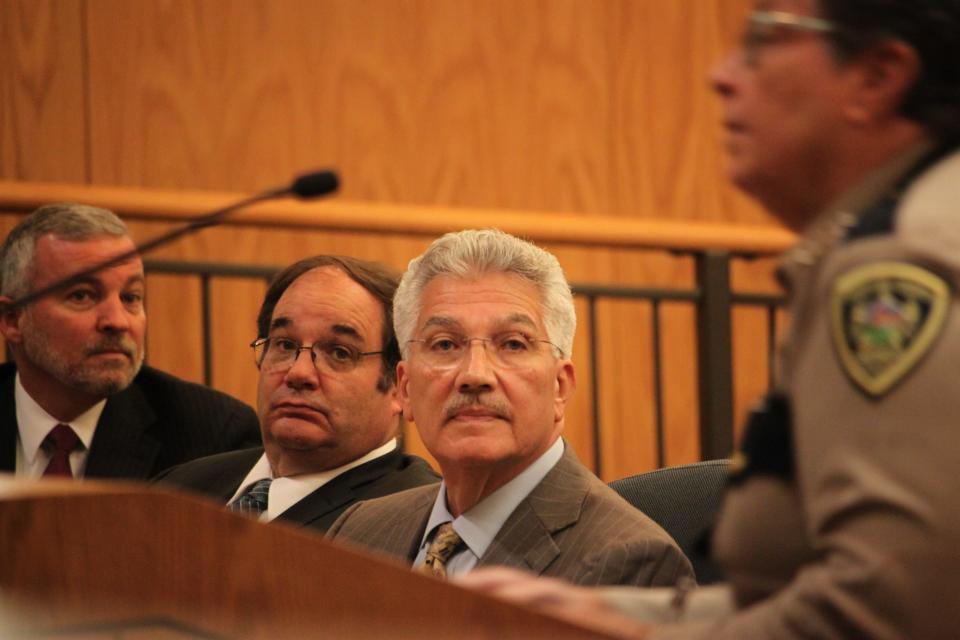 Doña Ana County Manager Fernando Macias, center, listens as Sheriff Kim Stewart addresses the Doña Ana County Board of Commissioners on Tuesday, Aug. 27, 2019.