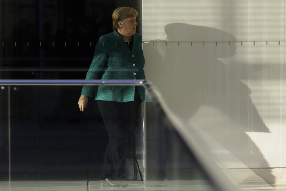 German Chancellor Angela Merkel walks through a corridor of the Reichstag building during a Christian Union parties faction meeting in Berlin, Tuesday, Sept. 25, 2018. (AP Photo/Markus Schreiber)