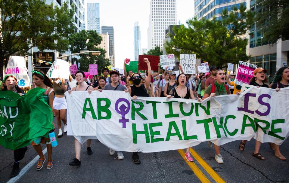 Abortion-rights protesters march in downtown Austin, Texas, following the Supreme Court decision to overturn Roe v. Wade in June 2022. In 2021, Texas passed what's called a "trigger law," common in conservative states: If Roe were overturned, most abortions would become illegal, with no further action required.