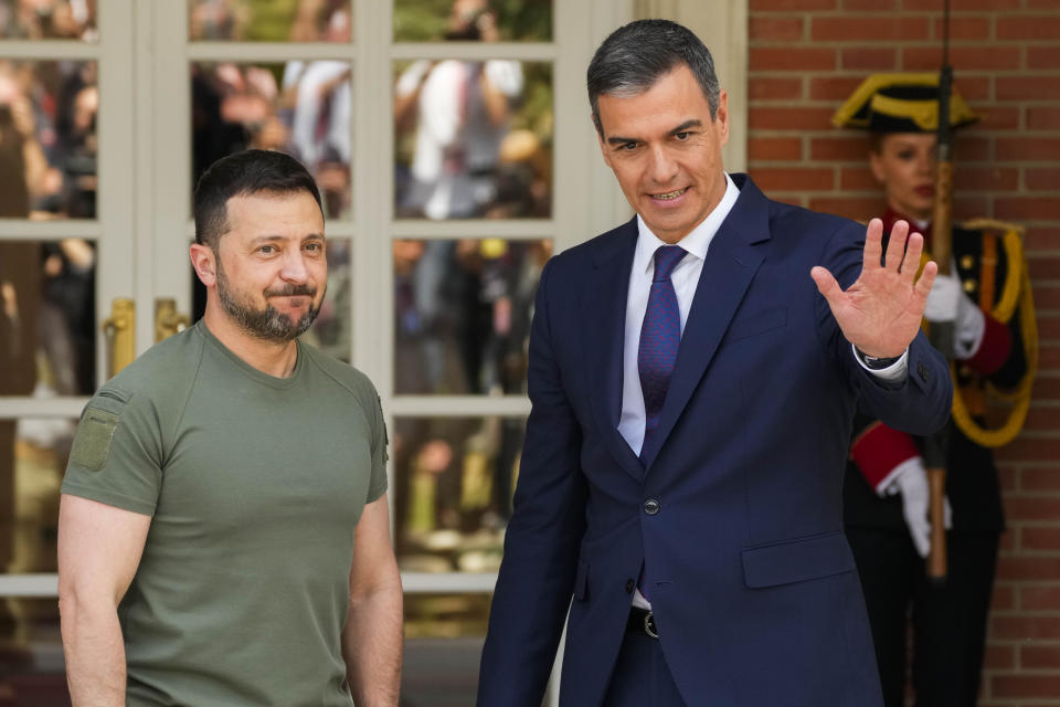 Ukrainian President Volodymyr Zelenskyy, left, is welcomed by Spain's Prime Minister Pedro Sanchez at the Moncloa palace in Madrid on Monday, May 27, 2024. (AP Photo/Paul White)