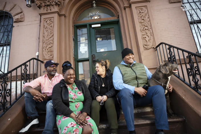 From left to right, Courtland Hankins III, Claudia Waterton, Lizzette Concepcion and Kevin Stone, outside their apartment building in the Port Morris neighborhood of the Bronx on April 29, 2022. (Karsten Moran/The New York Times)