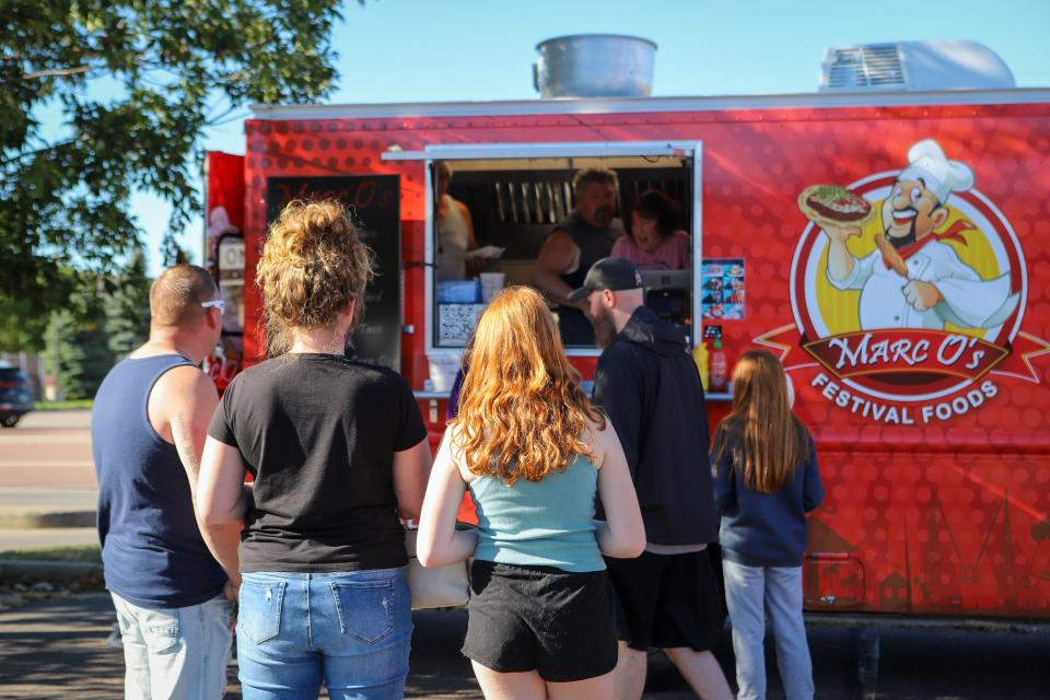 People wait in line to order from Marc O's Festival Foods food truck at Golf Addiction in Sioux Falls on Tuesday, August 30.