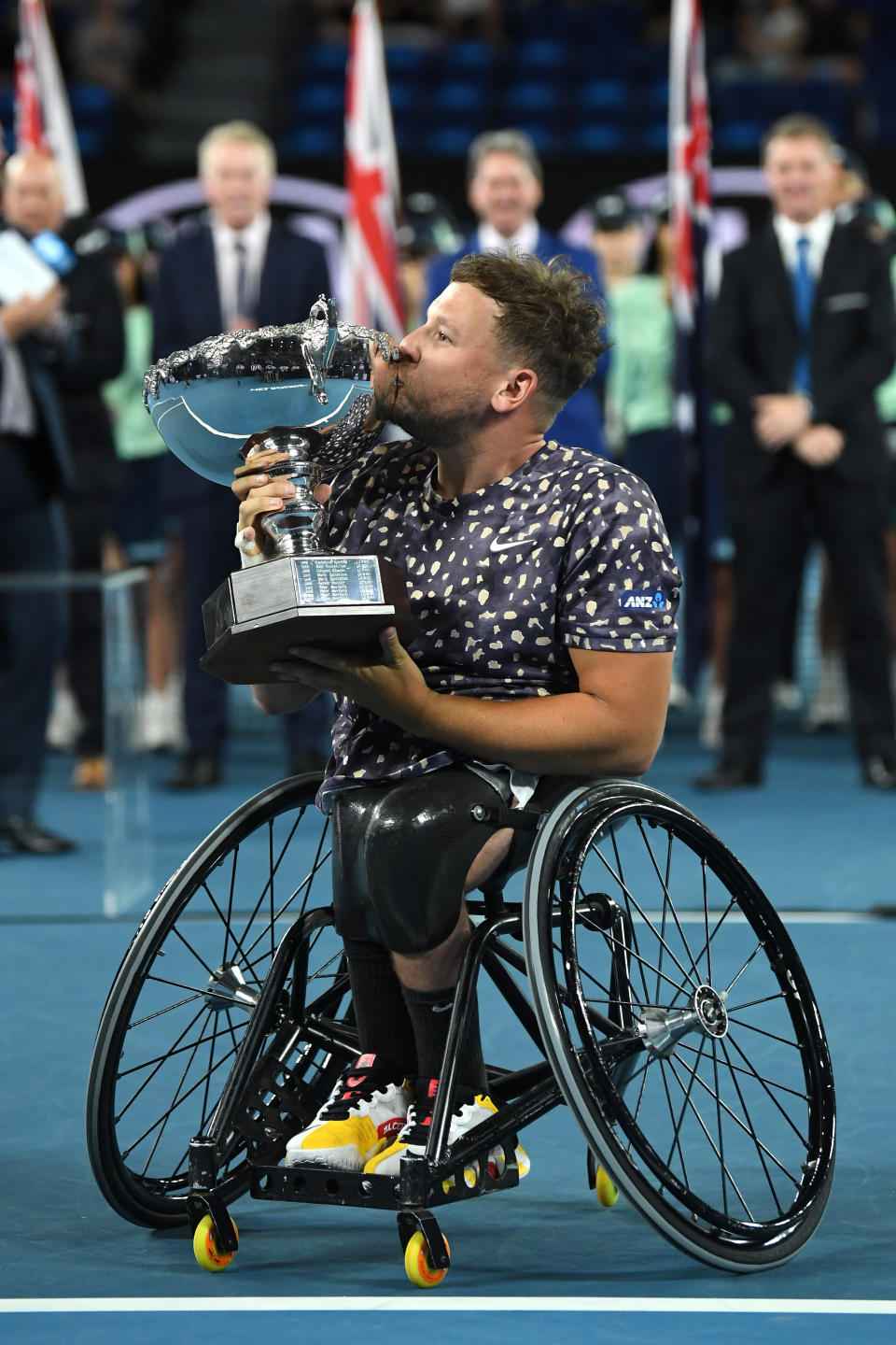 Dylan Alcott holds aloft the championship trophy.