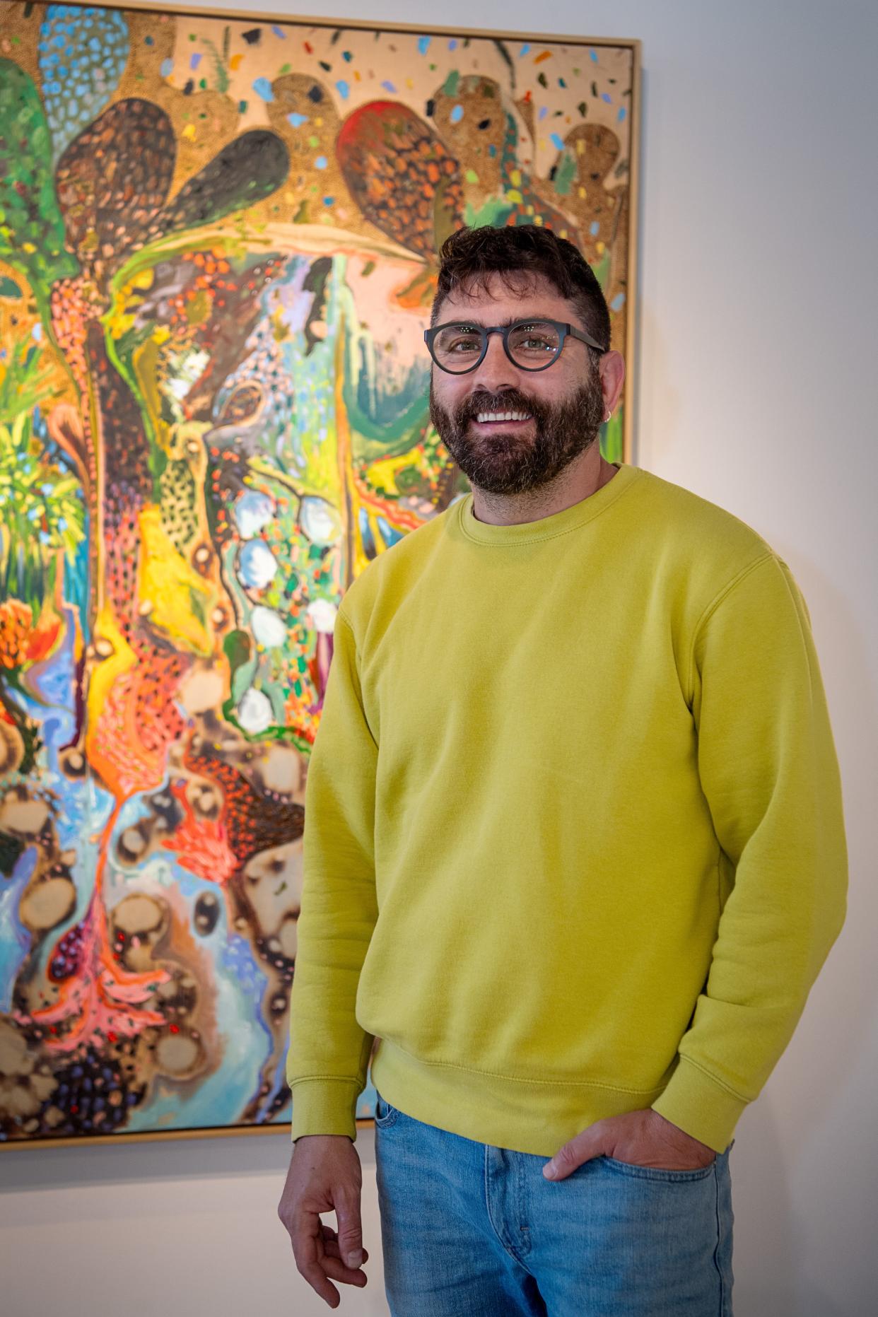 Artist Nabil El Jaouhari stands with his piece, “The Wind Will Carry Us,” at the Mark Bettis Gallery in the River Arts District in Asheville, March 4, 2024.