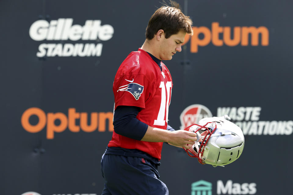 New England Patriots first round draft pick quarterback Drake Maye walks onto the field during the NFL football team's rookie minicamp Saturday, May 11, 2024, in Foxborough, Mass. (AP Photo/Mark Stockwell)