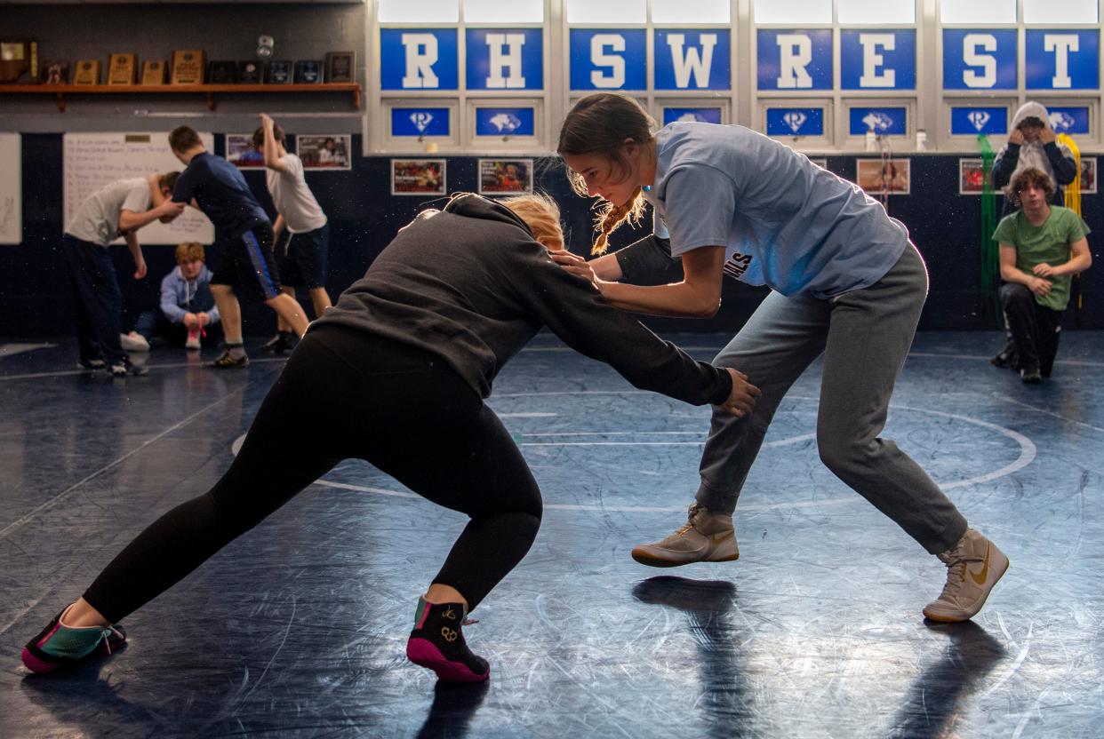 Makayla McCool, left, goes for the takedown on Lili Greenfield during practice at Reitz High School Thursday, Jan. 4, 2024.