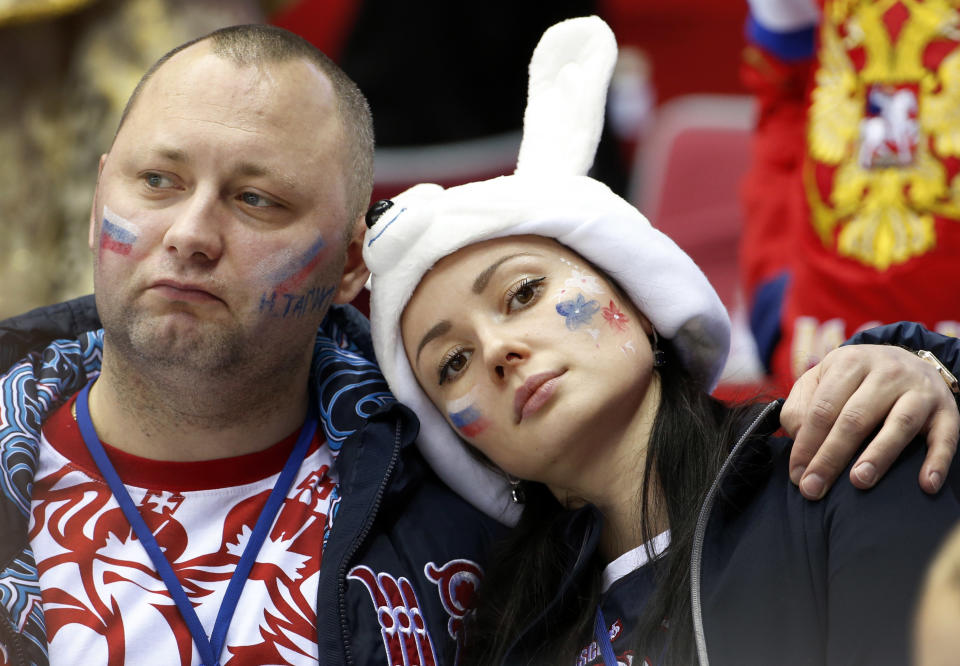 Russian hockey fans react at the end of a men's quarterfinal ice hockey game between Finland and Russia at the 2014 Winter Olympics, Wednesday, Feb. 19, 2014, in Sochi, Russia. Finland won 3-1. (AP Photo/Julio Cortez)