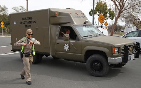 A sheriff's hostage negotiation team passes a California highway patrol checkpoint at the Veterans Home of California in Yountville - Credit: AP