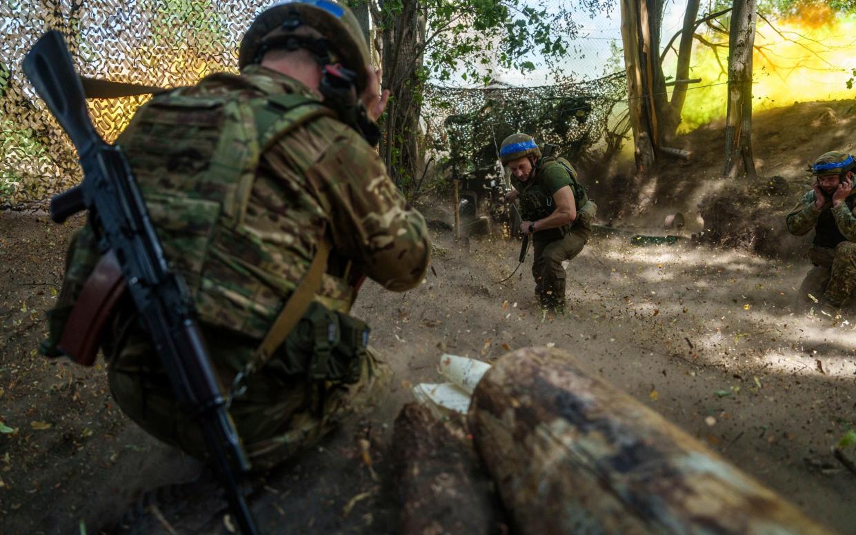 A Ukrainian national guard servicemen fires a D-20 cannon towards Russian positions at the frontline near Kharkiv