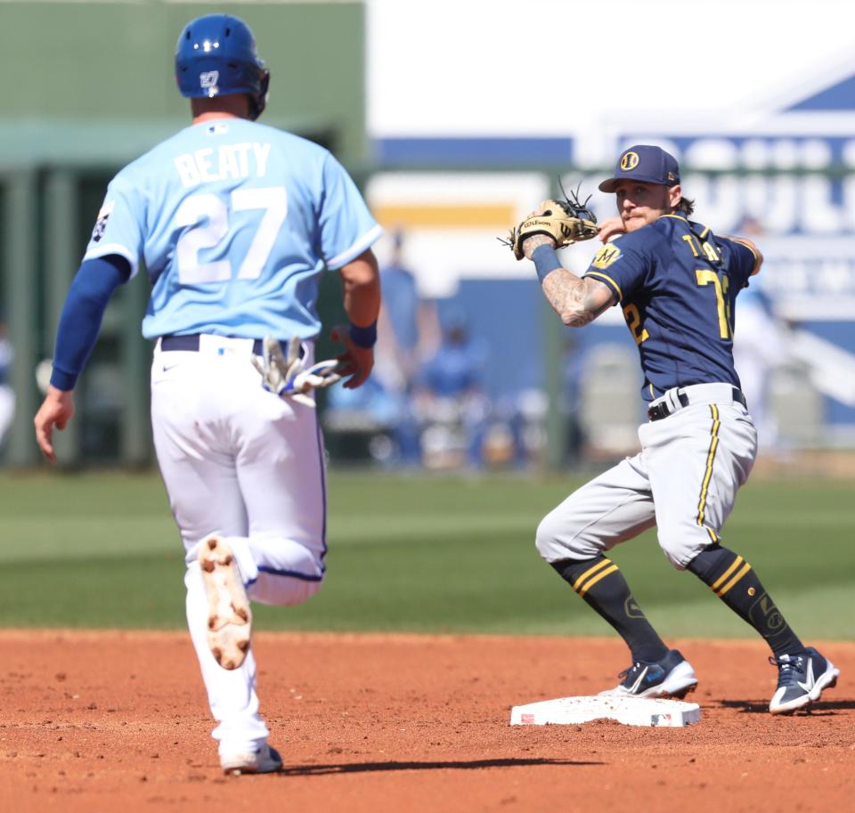 Milwaukee Brewers Brice Turang prepares to throw over Matt Beaty of the Kansas City Royals to complete a double play, Monday, February 27, 2023.