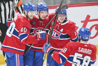 Montreal Canadiens' Joel Armia (40) celebrates with teammates Alex Newhook (15), Brendan Gallagher (11) and David Savard after scoring against the Tampa Bay Lightning during first-period NHL hockey game action in Montreal, Thursday, April 4, 2024. (Graham Hughes/The Canadian Press via AP)