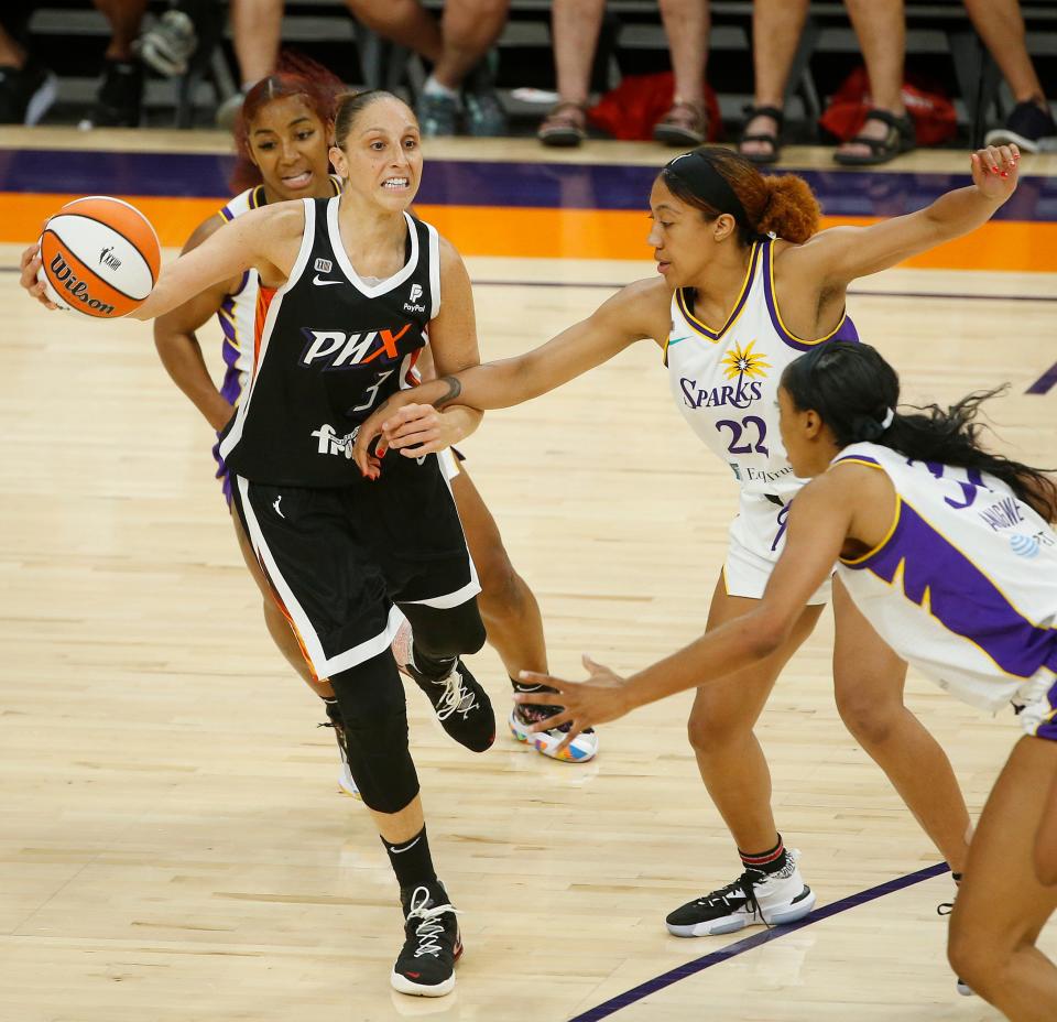The Mercury's Diana Taurasi (3) swings a pass into the post against the Sparks' Arella Guirantes (22) during the second quarter.