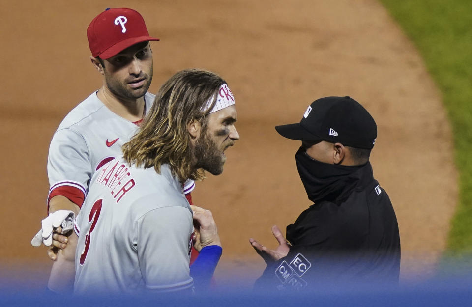 Philadelphia Phillies' Bryce Harper, front left, argues with umpire Roberto Ortiz, right, after Ortiz ejected Harper during the fifth inning of the team's baseball game against the New York Mets, Saturday, Sept. 5, 2020, in New York. (AP Photo/John Minchillo)