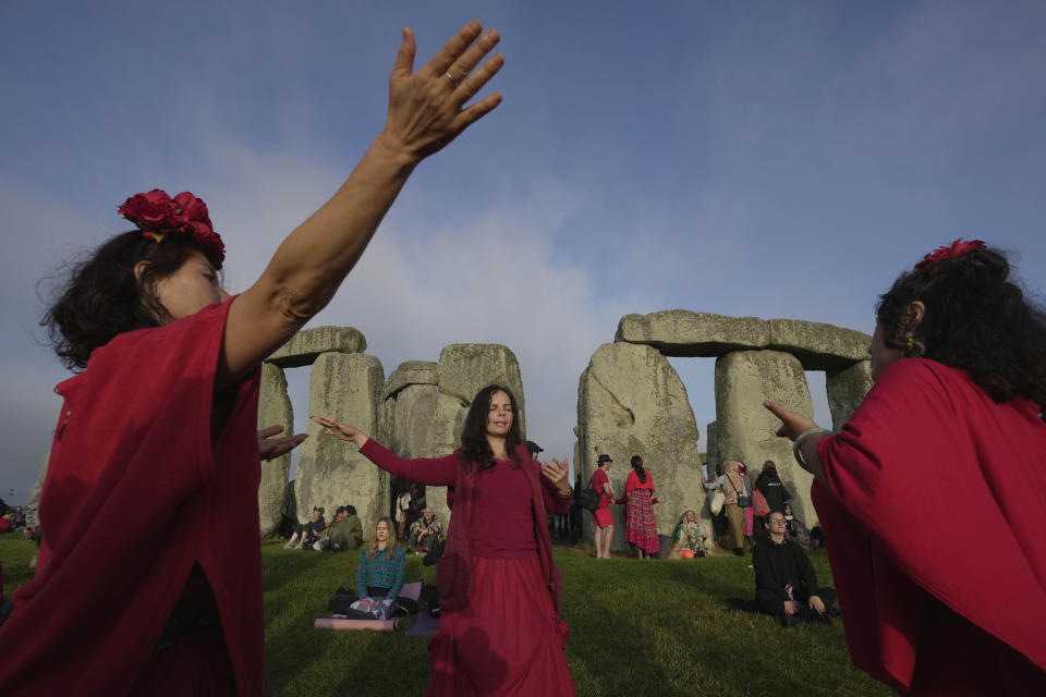 Revelers gather at the ancient stone circle Stonehenge to celebrate the Summer Solstice, the longest day of the year, near Salisbury, England, Wednesday, June 21, 2023. (AP Photo/Kin Cheung)