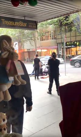 Emergency responders helping to injured are seen near the Bourke Street mall in Melbourne, Australia, November 9, 2018 in this picture grab obtained from social media video. WEIBO/@DEARRUTHIE/via REUTERS