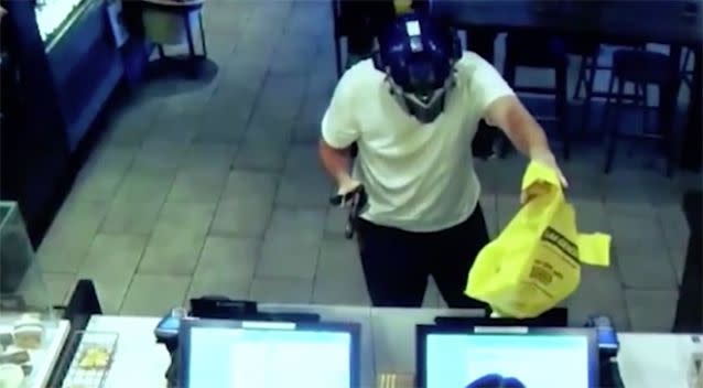 The alleged thief approaches the counter wielding a knife and gun-shaped item. Source: Fresno Police