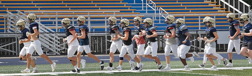 Archbishop Williams football players work out at practice in Braintree on Monday, Aug. 28, 2023.